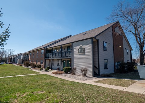 Apartment building number 715 is shown with a clear blue sky in the background.