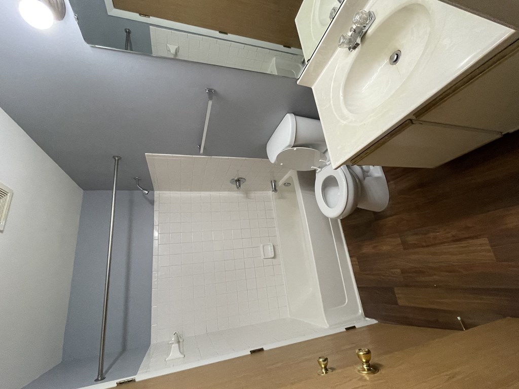 a small bathroom with a shower and a sink