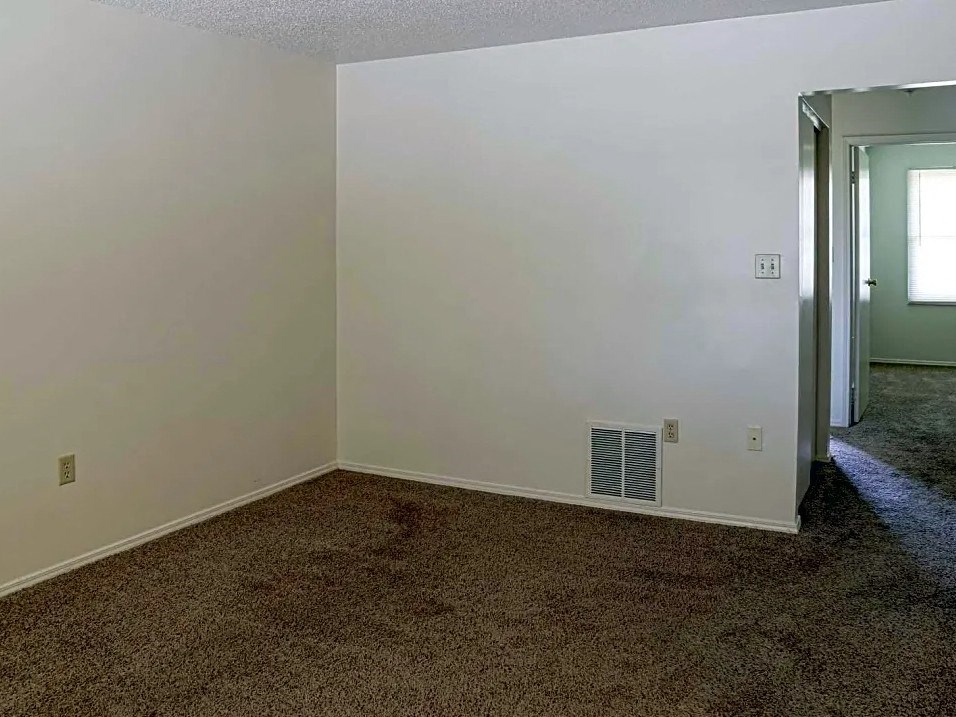 a room with a carpet and a heater in it