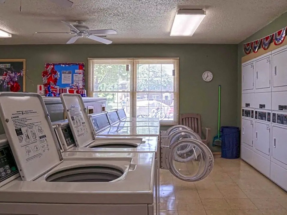 a laundry room with a counter and a washer and dryer