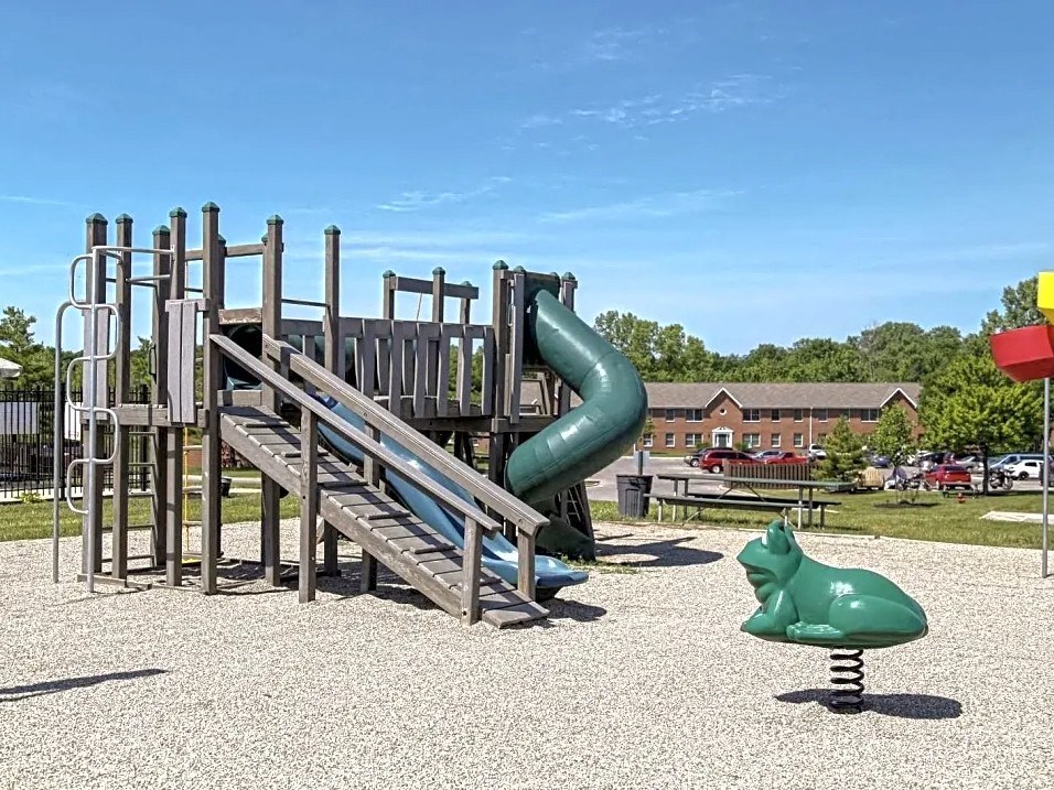 a playground with a slide at a park