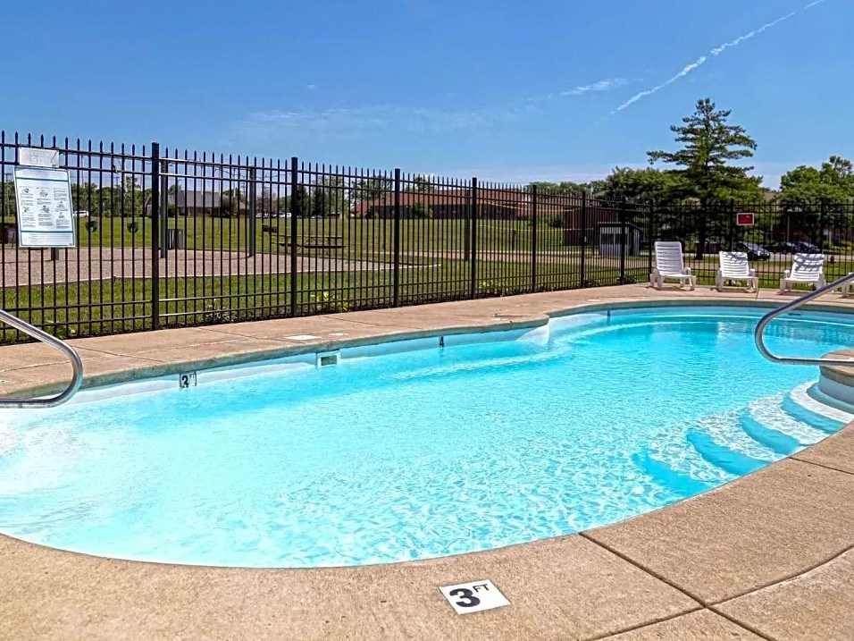a resort style swimming pool with a fence around it