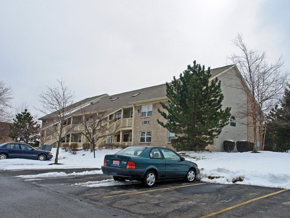 a car parked in front of an apartment building