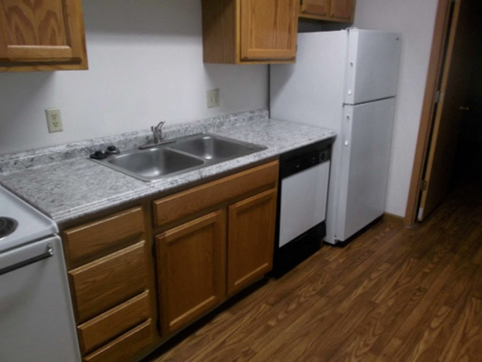 a kitchen with a sink and a refrigerator