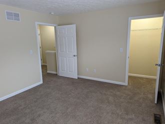an empty room with a door and a closet