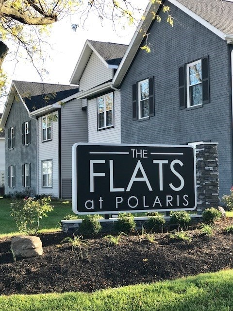 the flats at polaris sign in front of a house