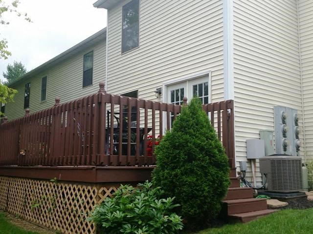 a white house with a fence in front of it