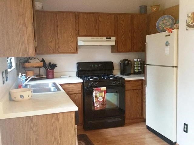 a kitchen with a stove and a refrigerator