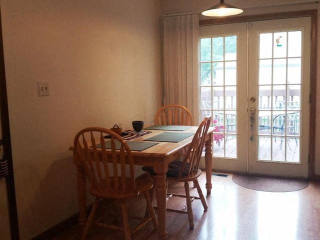 a table and chairs in a room with doors