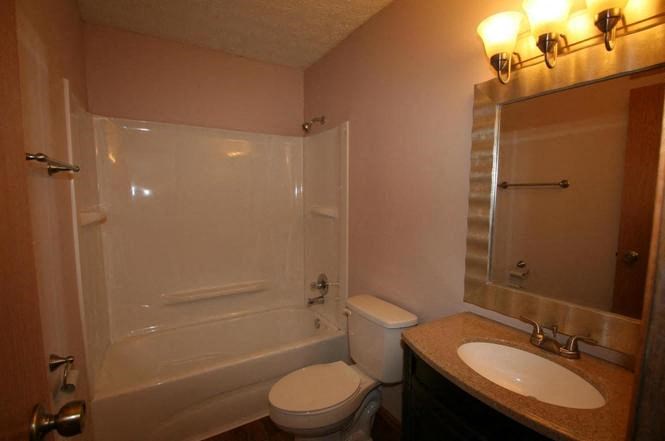 a bathroom with a sink toilet and a shower