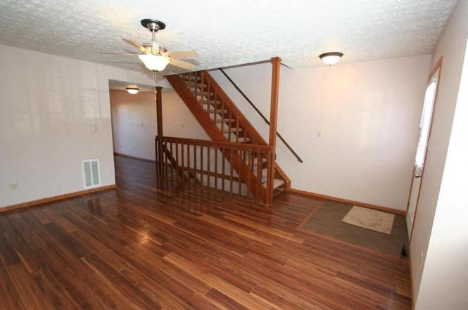 a living room with a staircase in a house