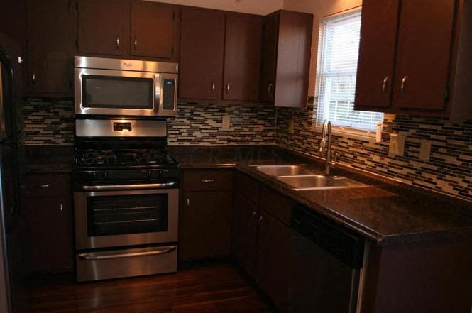 a kitchen with stainless steel appliances and a sink