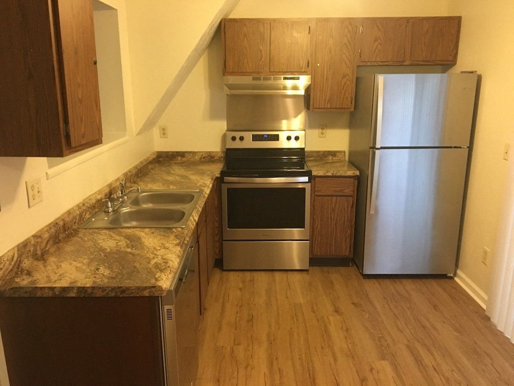 a kitchen with stainless steel appliances and marble counter tops