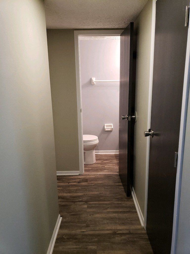 a small bathroom with a toilet and a door