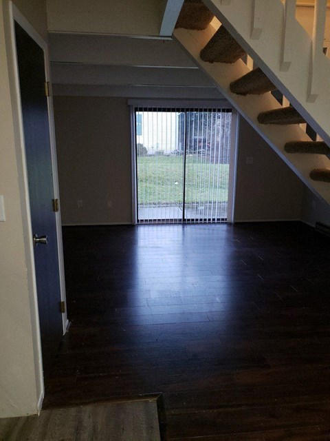 a empty living room with a sliding glass door