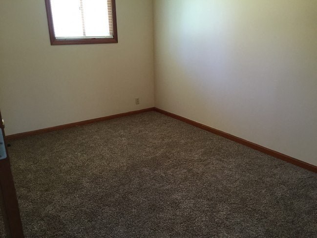 Bedroom with wooden floor and window at Dutch Hills Terrace Apartments, Parkersburg, West Virginia