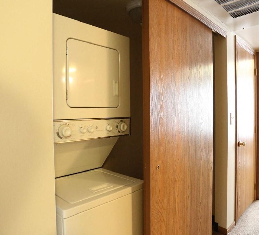 A white oven and stove top are in a kitchen.