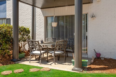 a patio with a table and chairs on a patio