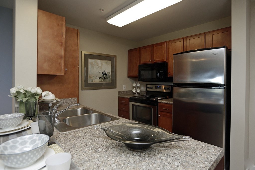 a kitchen with stainless steel appliances and granite counter tops