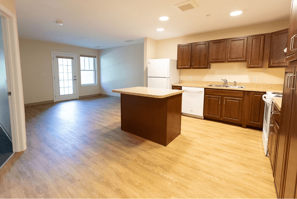 A kitchen with wooden cabinets and a white refrigerator.