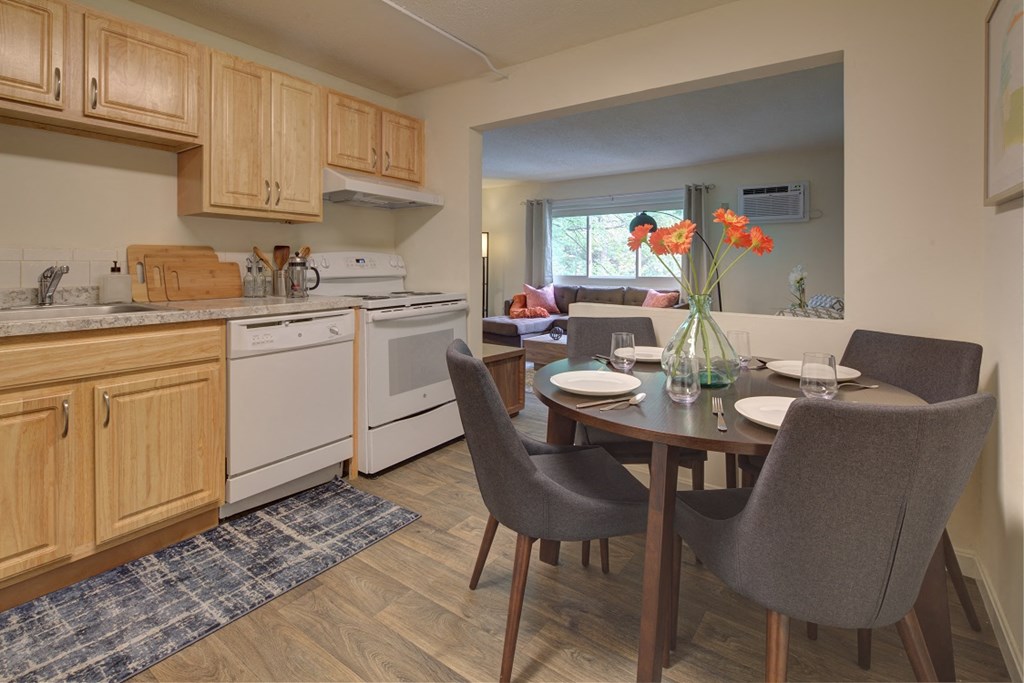 a kitchen and dining room with a table and chairs