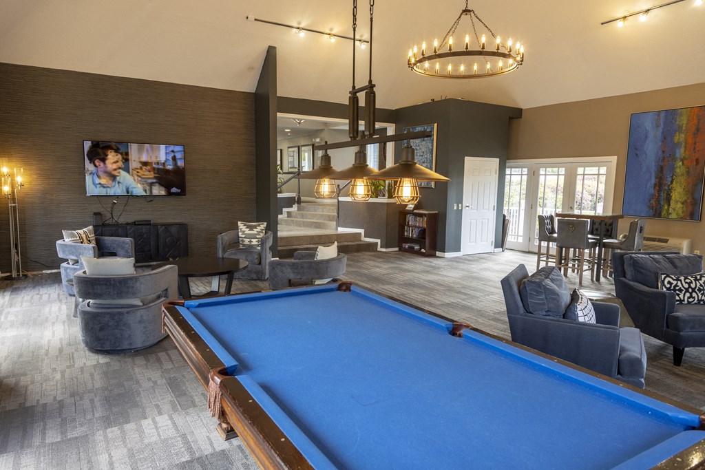 a large living room with a pool table and a tv