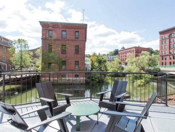a patio with chairs and a table on a balcony