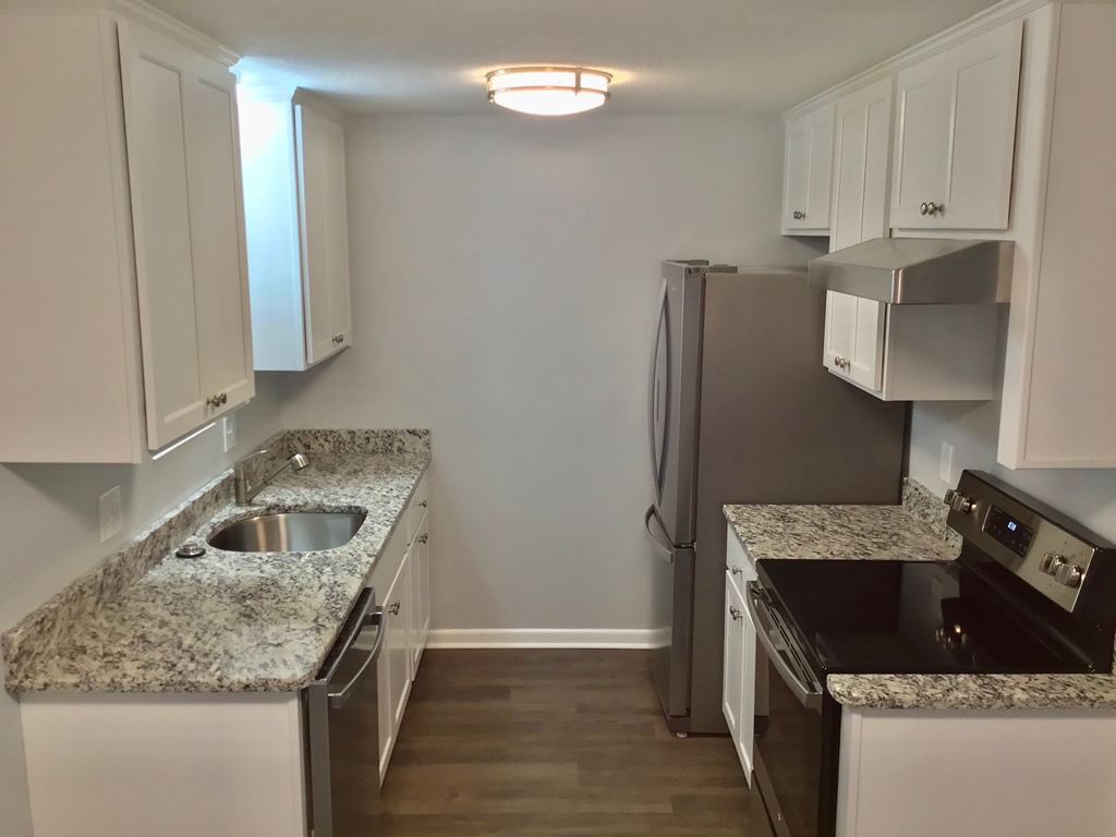 A kitchen with granite countertops and stainless steel appliances.