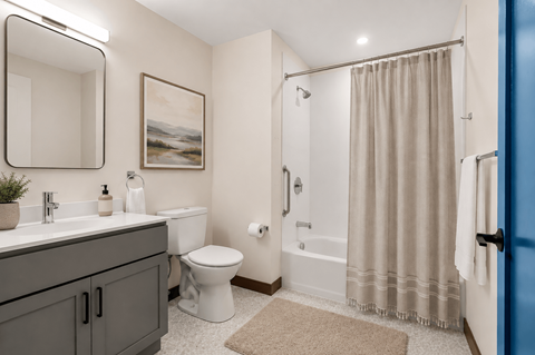 A bathroom with a toilet, sink, and shower.