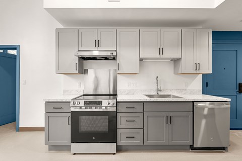 A modern kitchen with a stainless steel oven and sink.