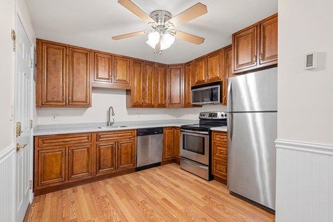 A kitchen with wooden cabinets and stainless steel appliances.