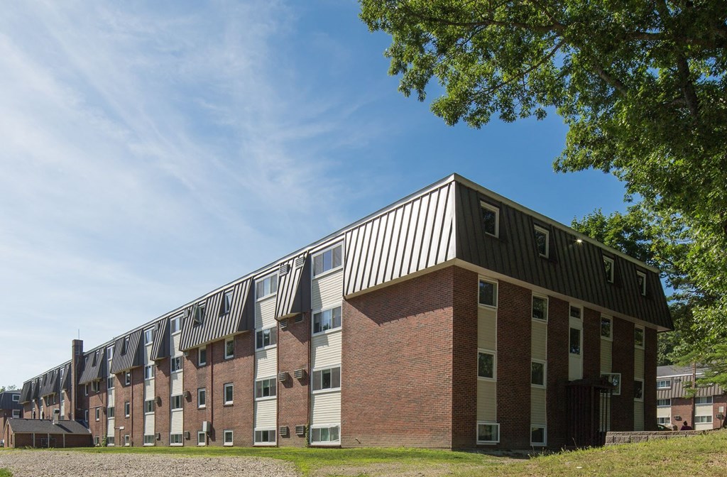 a brick apartment building with a blue sky in the background