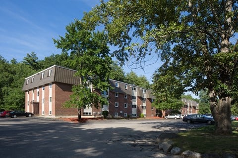 A large building with a parking lot in front of it.
