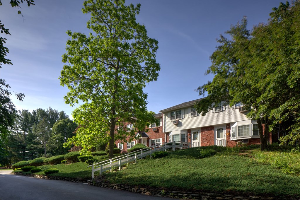 A tree in front of a house.