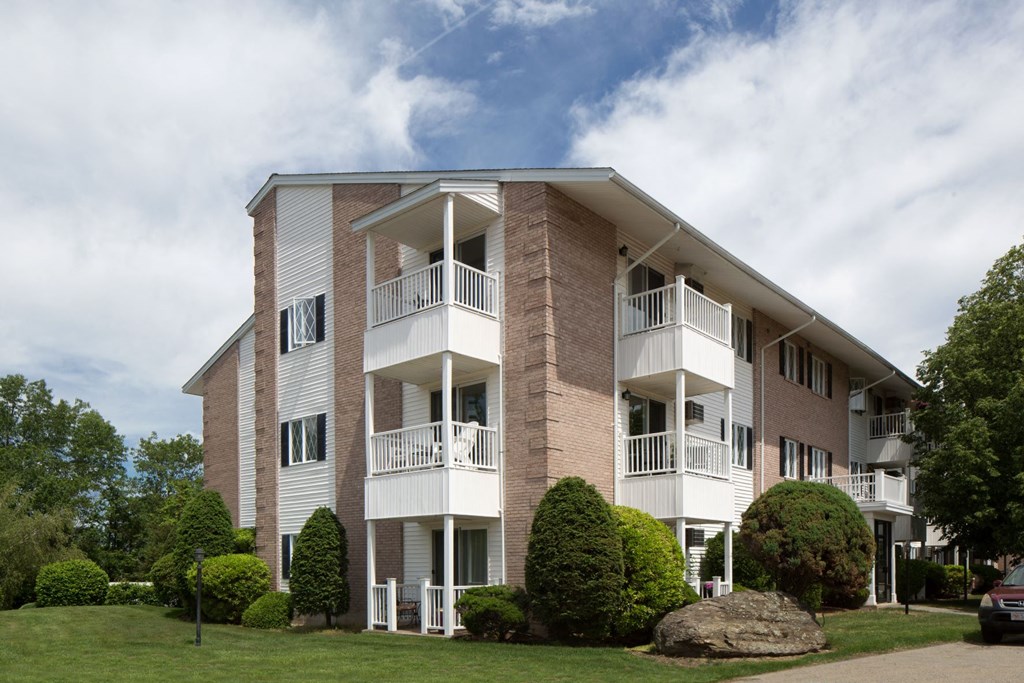 A large apartment building with a balcony on the second floor.