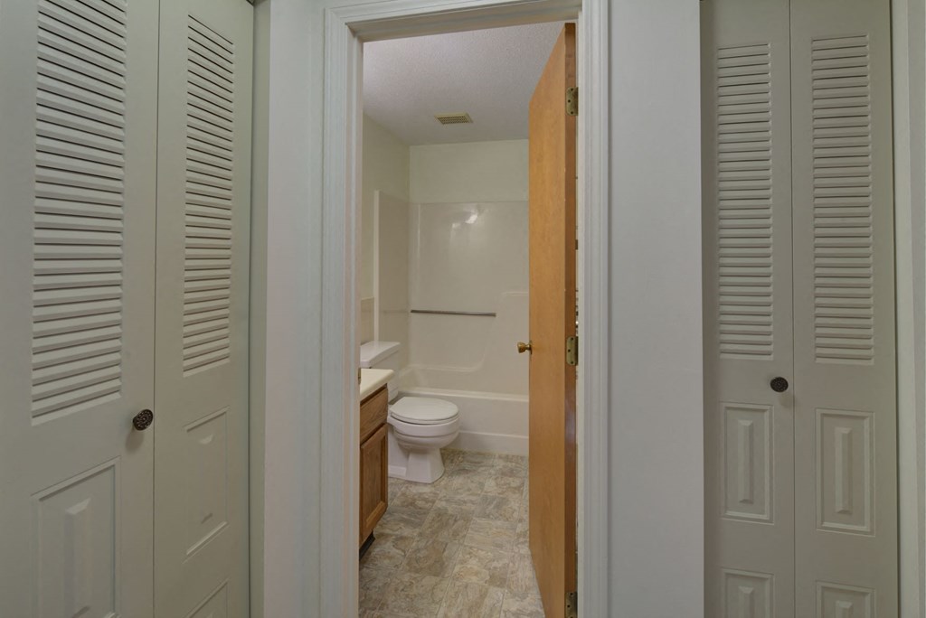 A white bathroom with a toilet and sink.