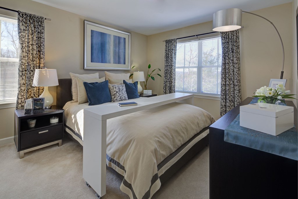 a bedroom with a bed and a dresser and a window