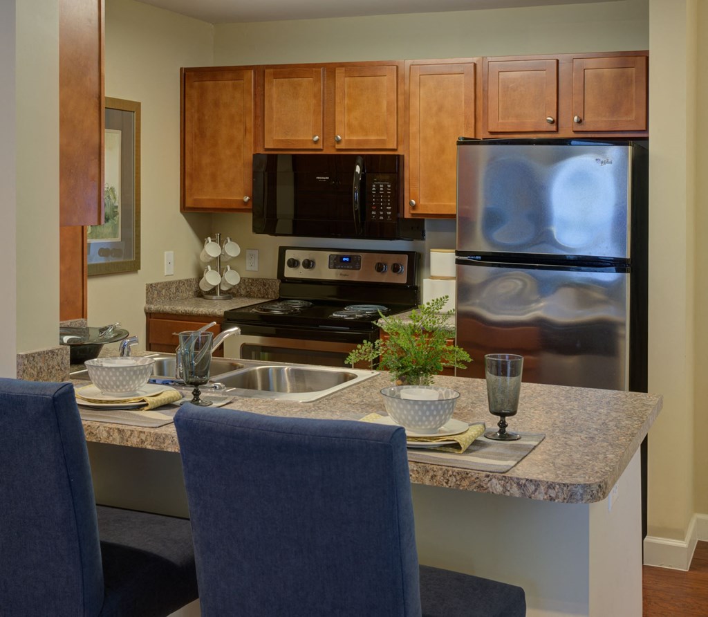 a kitchen with granite counter tops and stainless steel appliances