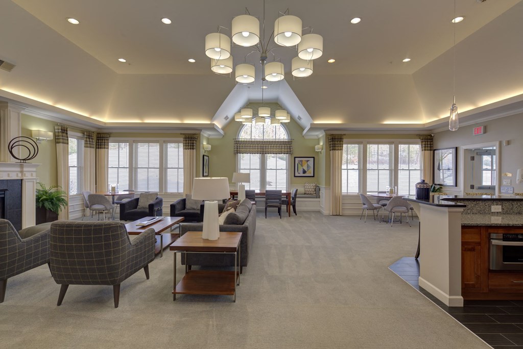 a large living room with couches and chairs and a table