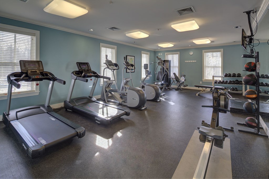 a gym with cardio equipment and weights in a residence hall