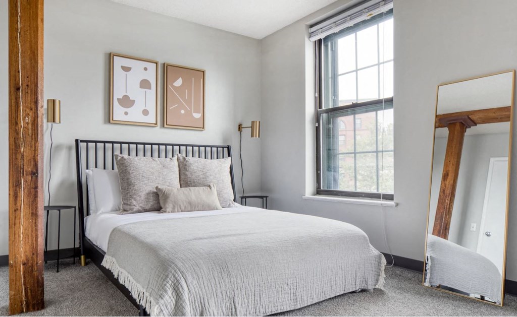 a bedroom with a bed and a window