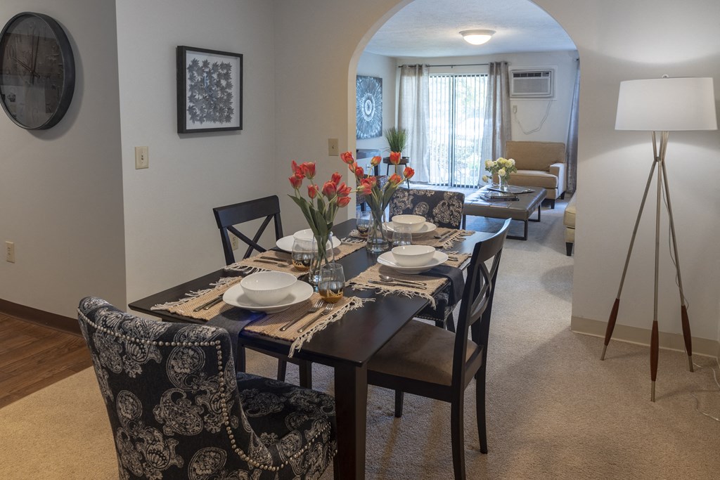 a dining room with a table and chairs and a living room
