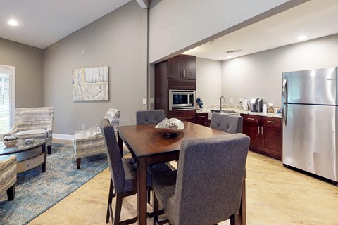 A modern kitchen with a dining table and chairs.