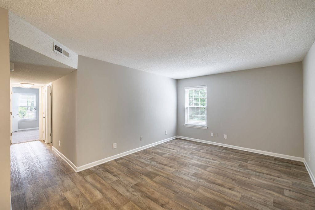 A room with wooden flooring and a window.