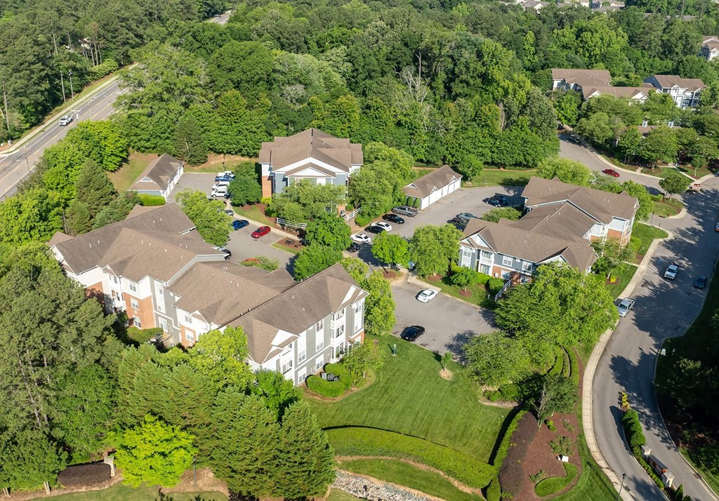A bird's eye view of a residential area with houses and cars.