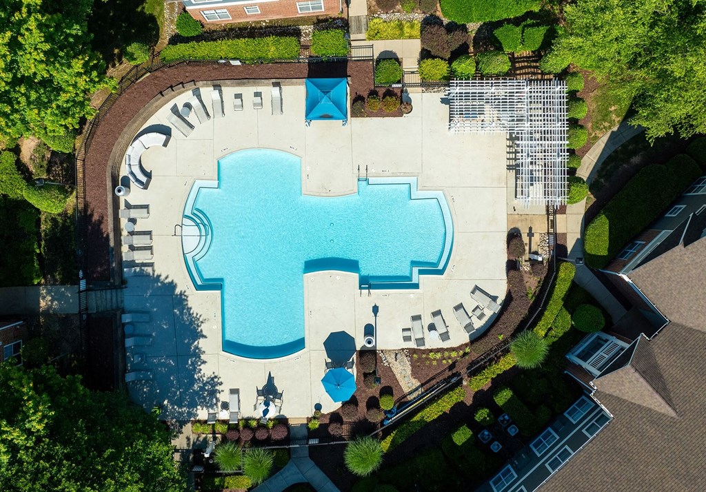 An aerial view of a pool with a blue water slide.