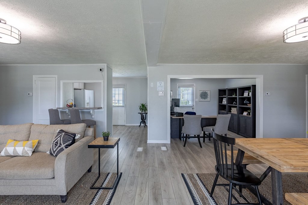 A living room with a grey couch and a wooden table.