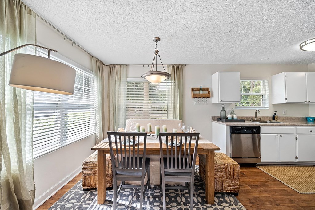 A dining room with a table set for two.