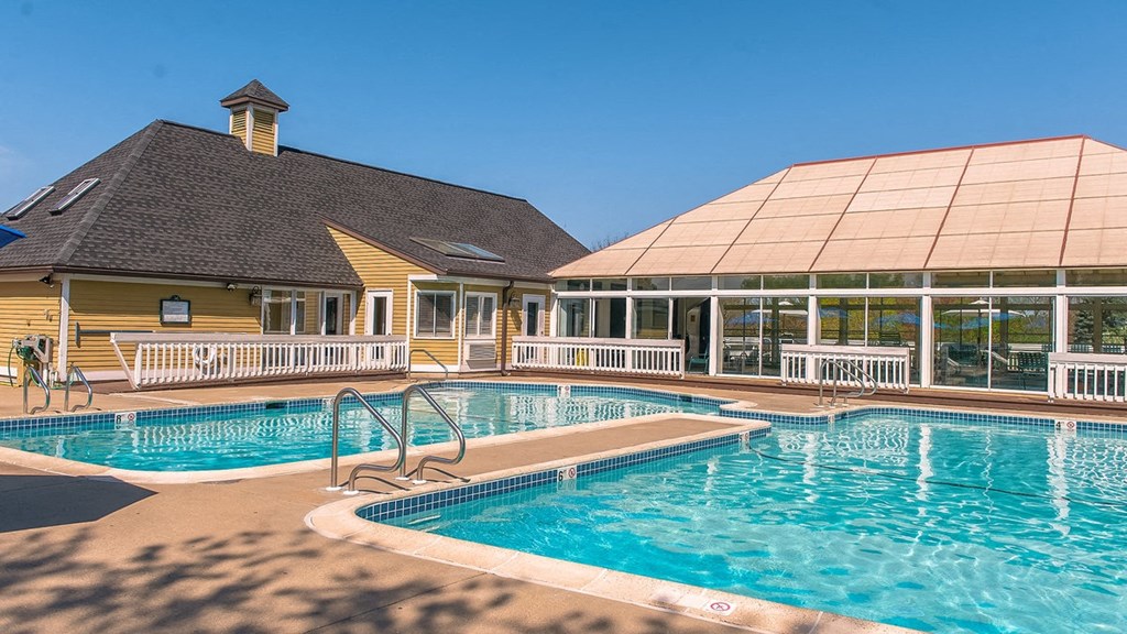 a resort style pool with a building in the background