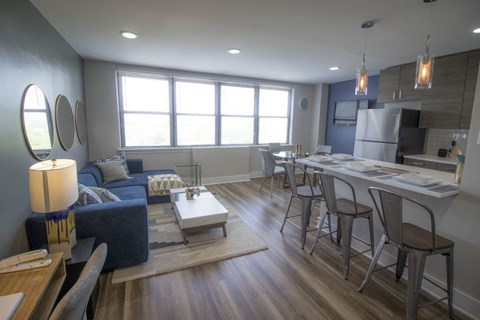 A modern living room with a blue couch and a wooden coffee table.